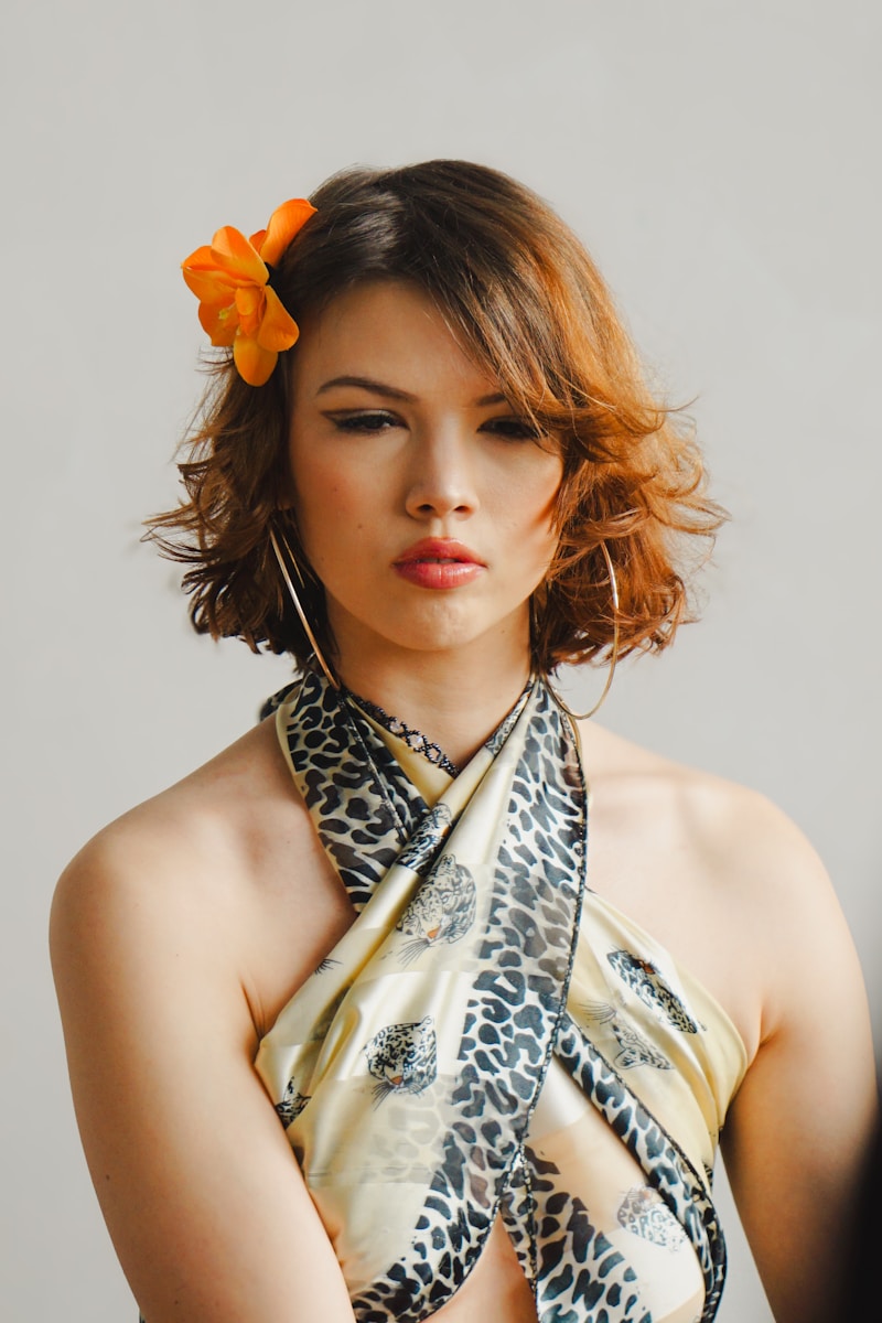 A woman with an orange flower in her hair